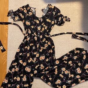 Maternity black floral pant romper. Faux buttons, short tied sleeves, waist tie.